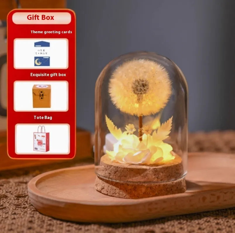 Glass dandelion-shaped night light ornament glowing with a soft LED light in a gradient colour.