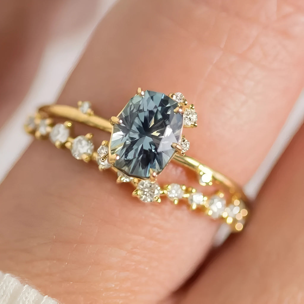 Gold-coloured floral fashion ring with a central green zircon stone on a white background.
