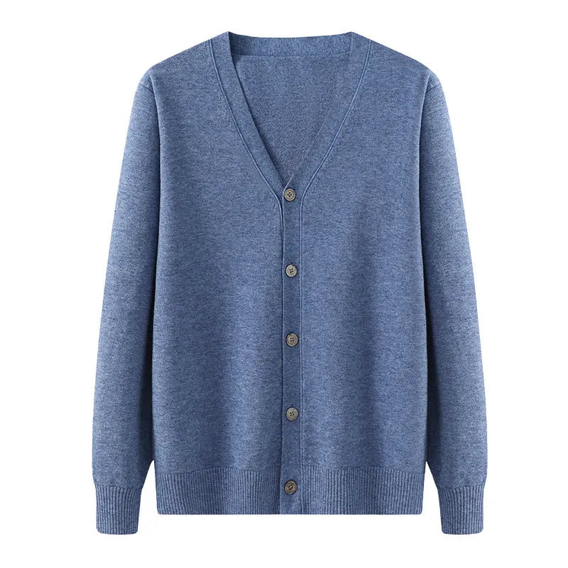 Man wearing a loose beige Andy velvet V-neck cardigan coat with long sleeves