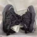 Grey women's chunky retro platform sneakers with thick rubber sole and lace-up front.