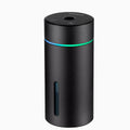 Black portable aluminium car air humidifier and essential oil diffuser with night light on a desk.