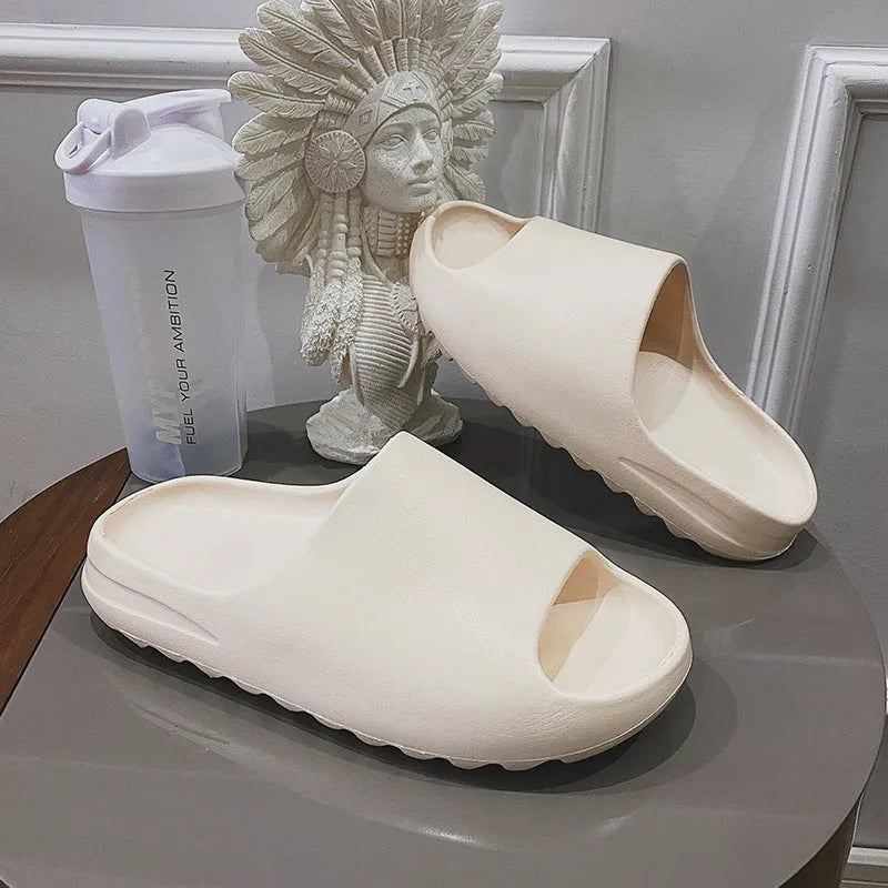 Women's thick sole beach slippers in black, green, and brown colours on a plain background