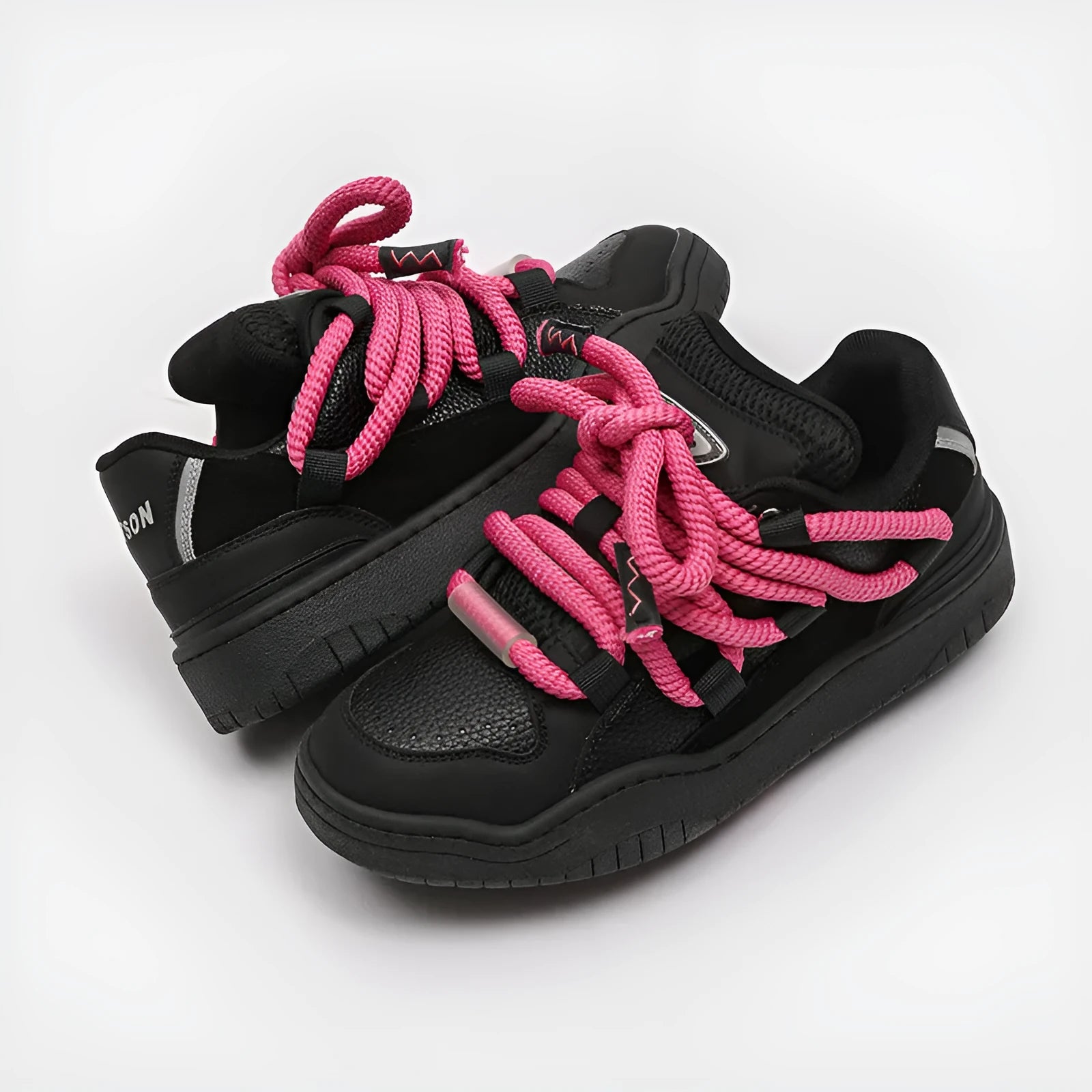 A pair of low-top casual sneakers with a thick rubber sole and front lace-up closure, shown in a choice of four colours.