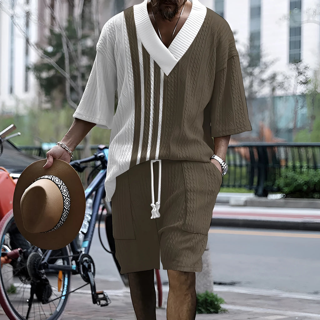 Man wearing a printed drop-shoulder knitted short sleeve top with matching shorts, a casual two-piece loungewear set.