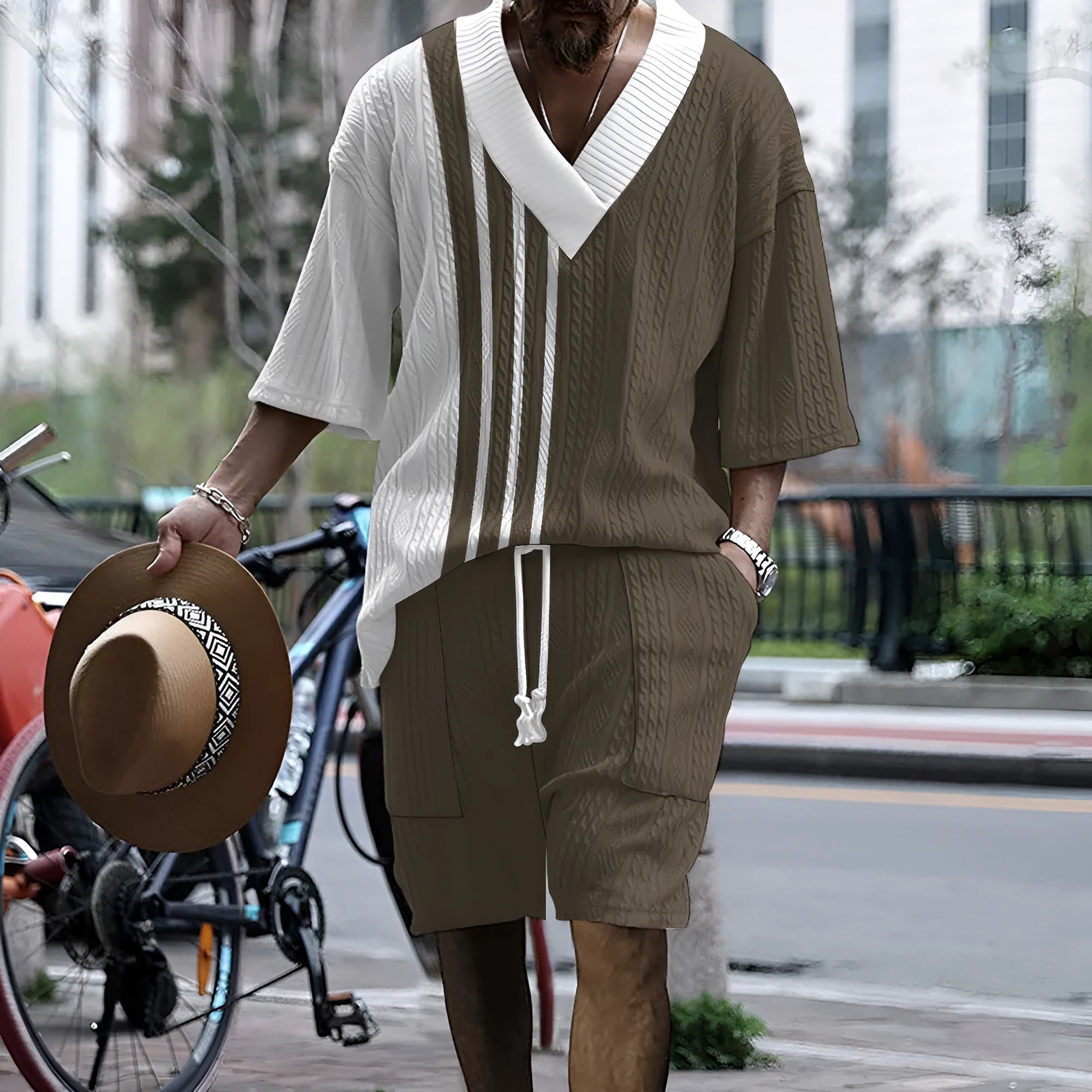 Man wearing a printed drop-shoulder knitted short sleeve top with matching shorts, a casual two-piece loungewear set.