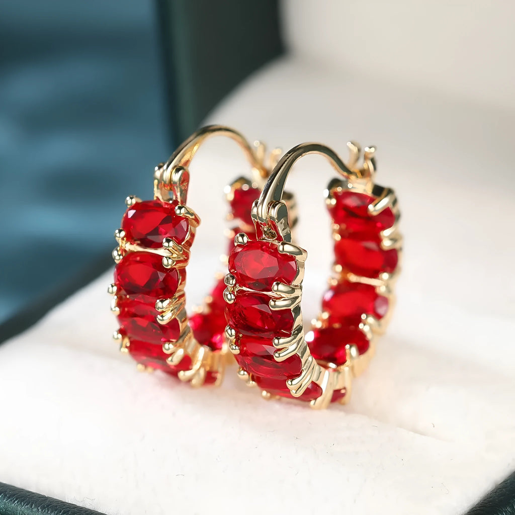 Egg-shaped ear clip earrings for women in electroplated copper, shown in platinum emerald, platinum sapphire blue and gold red