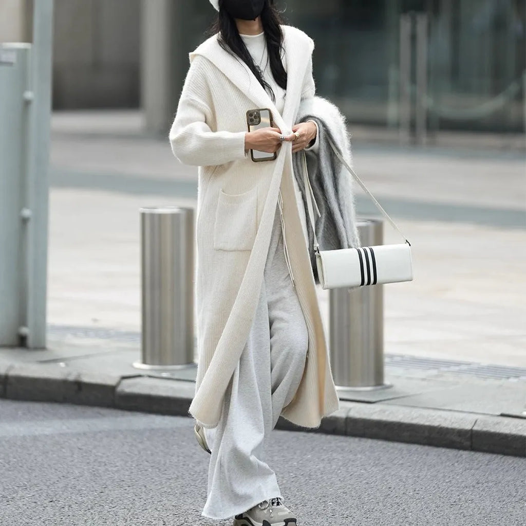 Women's long grey knitted cardigan with hood in trench coat style with regular long sleeves