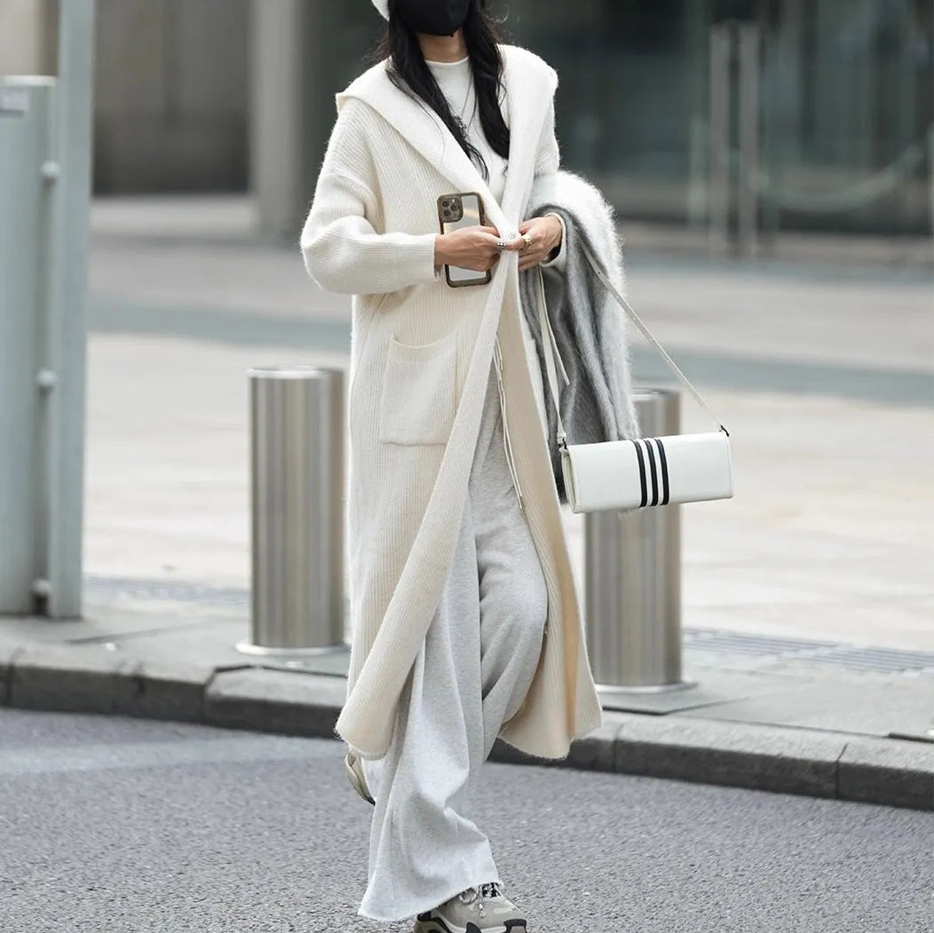 Women's long grey knitted cardigan with hood in trench coat style with regular long sleeves