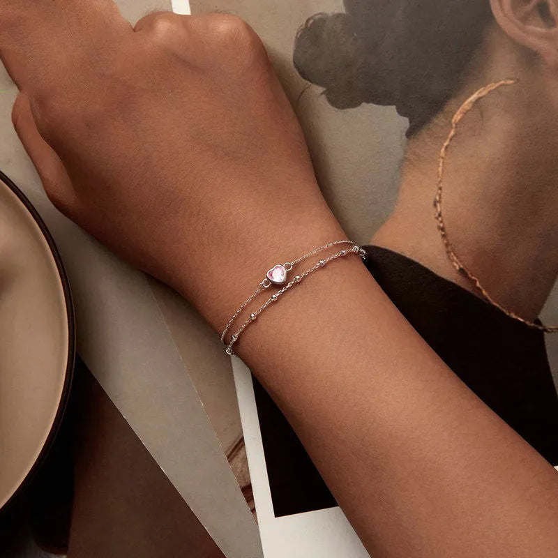 Women's 925 sterling silver bracelet with a small heart-shaped pendant on an adjustable chain.