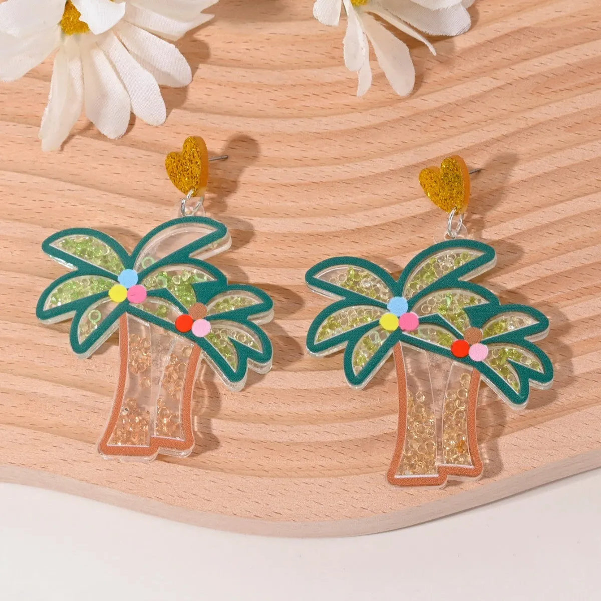 Acrylic drop earrings shaped like a strawberry, cherry, watermelon, pineapple, cake, ice cream, and coconut tree on a white background.