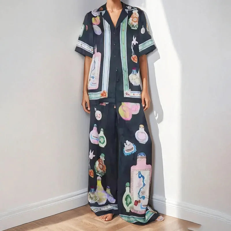 Women's black casual two-piece set with cartoon animation print, cardigan sleeve top, and matching trousers
