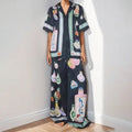 Women's black casual two-piece set with cartoon animation print, cardigan sleeve top, and matching trousers