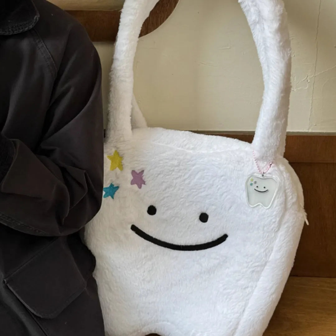 White large tote bag with plush large tooth shoulder strap and cute teeth design