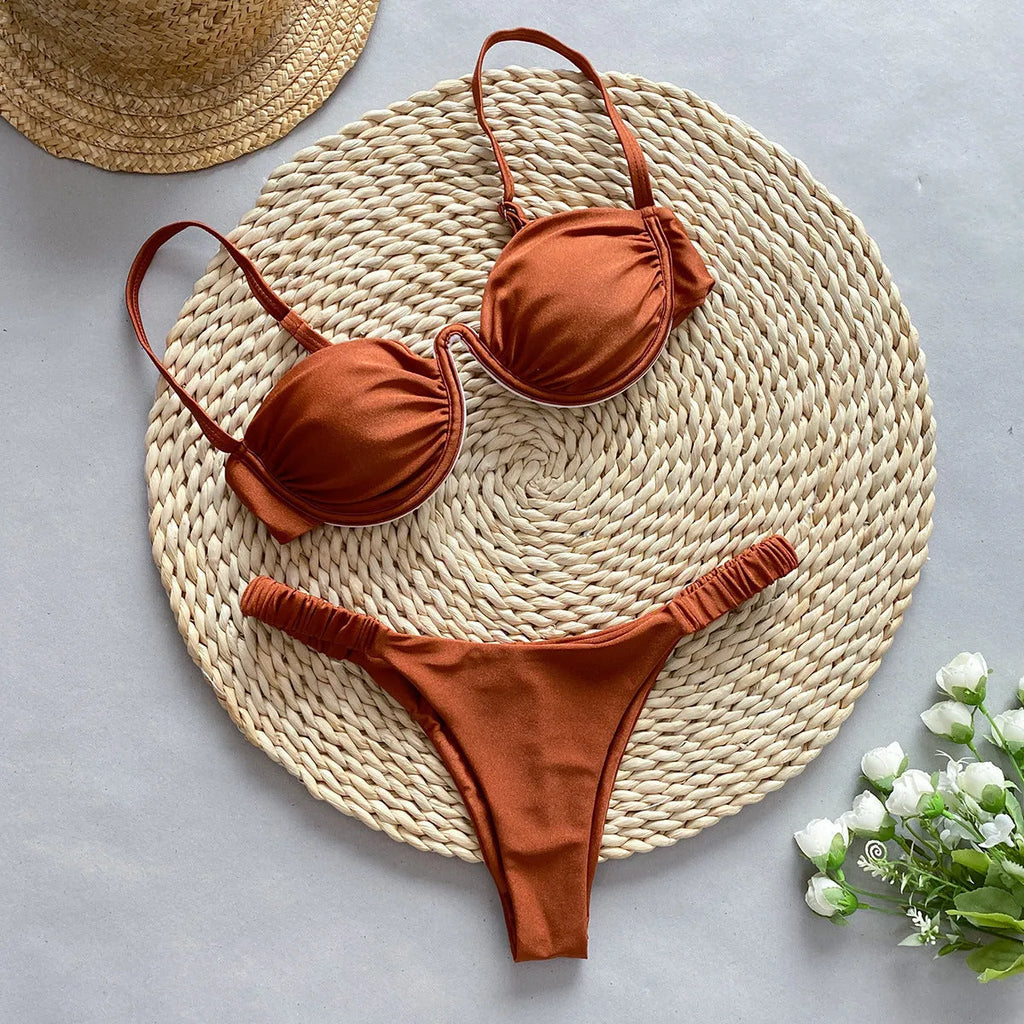 Women's black underwire bikini swimsuit set on a hanger.