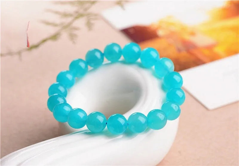 Natural amazonite scattered beads in blue-green ice colour showing polished surfaces and multiple size options