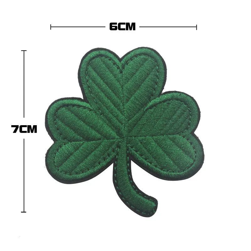 Outdoor embroidered fabric badge with Velcro strip showing clover design in green on nylon polyester material