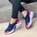 Women's white mesh flat sneakers with a round toe and non-slip rubber sole
