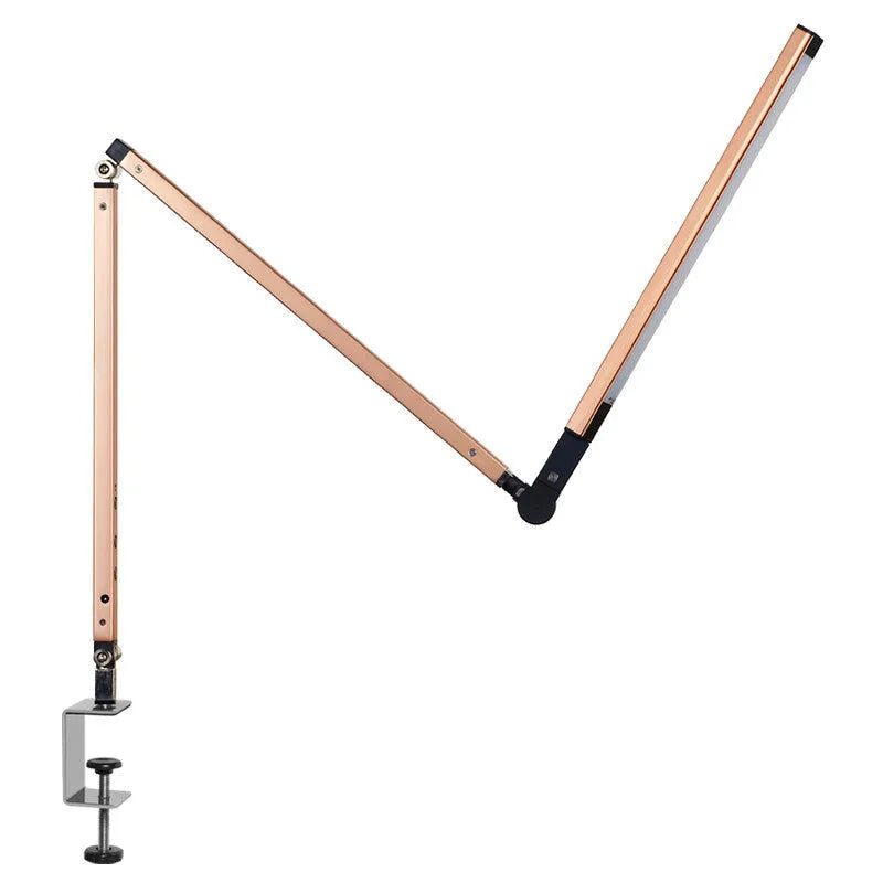 Clip-on aluminium desk lamp with remote control in dazzling black colour, mounted on a desk edge.