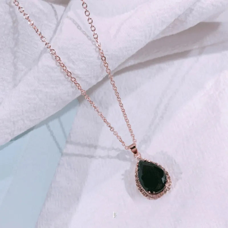 Drop-shaped pendant necklace with rhinestone and gemstone inlay in pink colour option