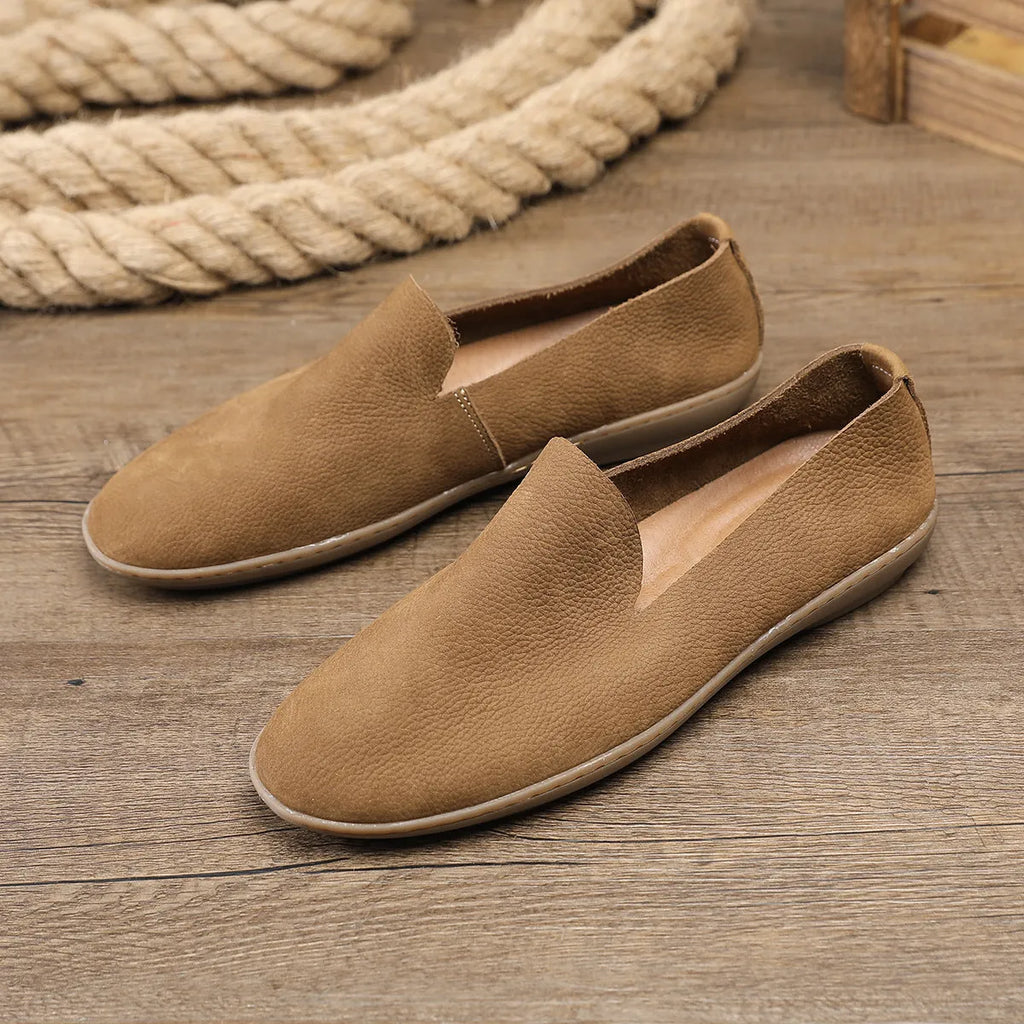 Handmade grey low top men's shoes with a wedge heel and rubber sole.