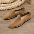 Handmade grey low top men's shoes with a wedge heel and rubber sole.