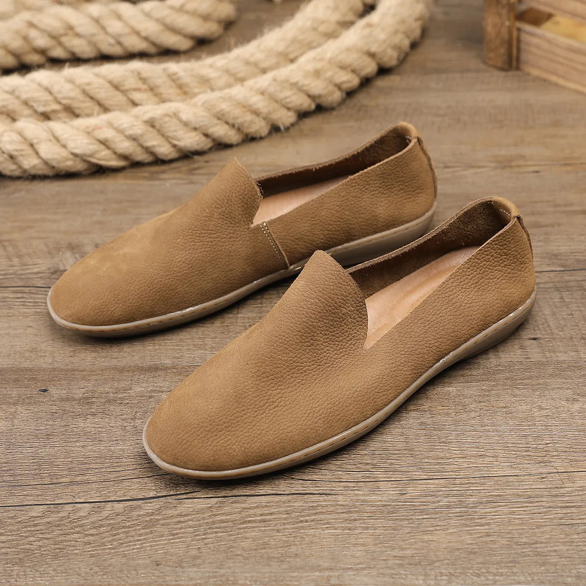 Handmade grey low top men's shoes with a wedge heel and rubber sole.