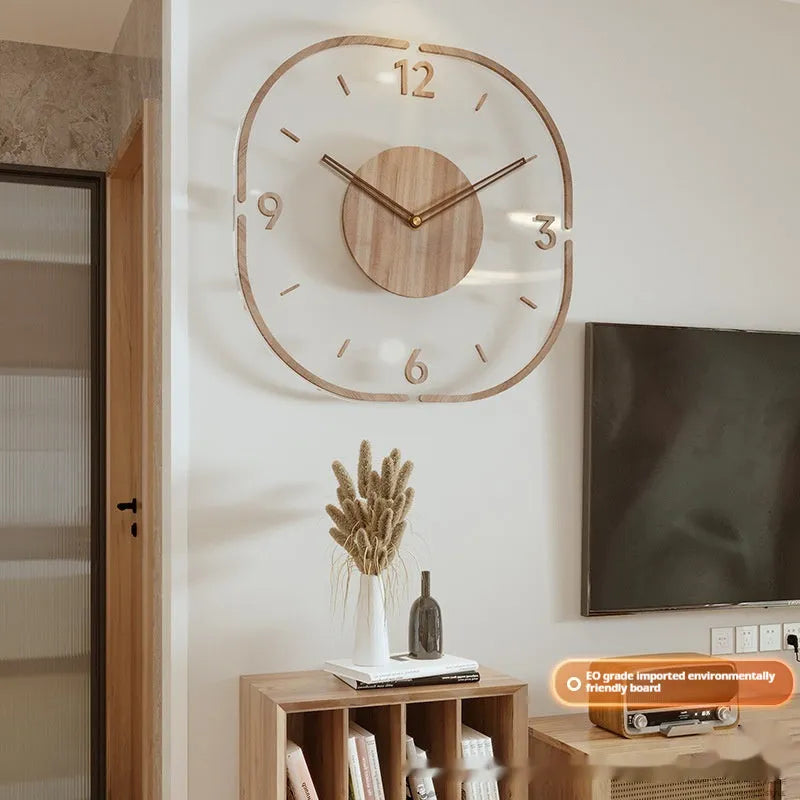 Square transparent wall clock with a wooden frame on a plain wall, showing modern design