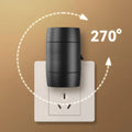 Small white plug-in night lamp with adjustable head shown in a UK wall socket