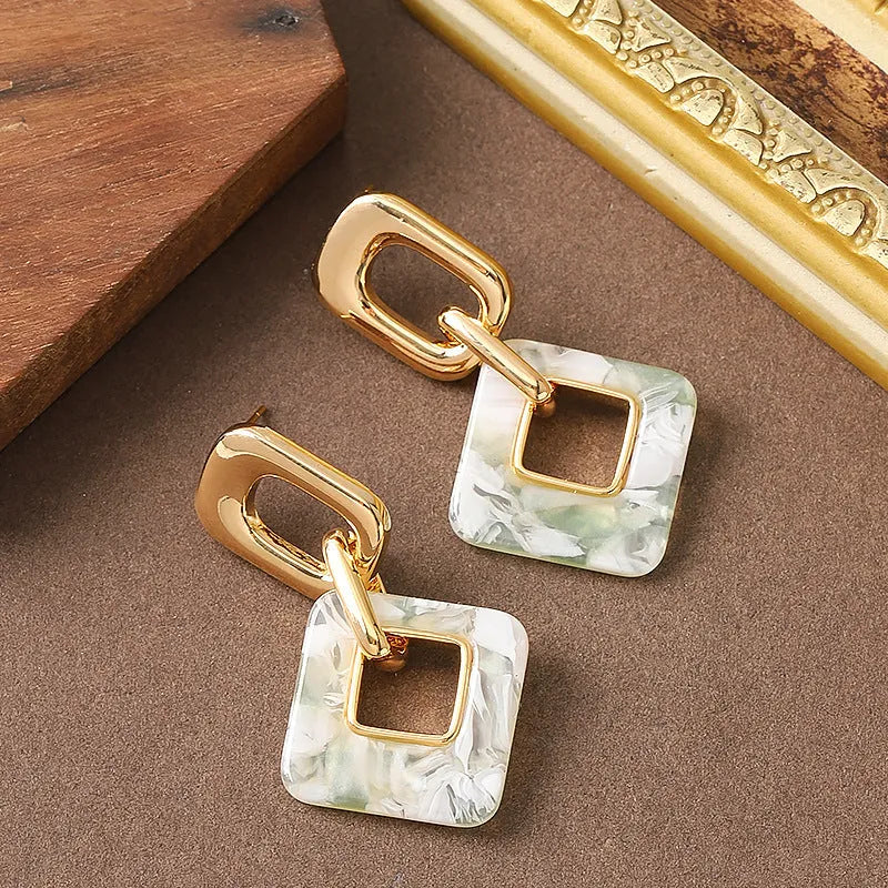 Copper geometric square earrings with hollow design and chamfered corners in metallic finish