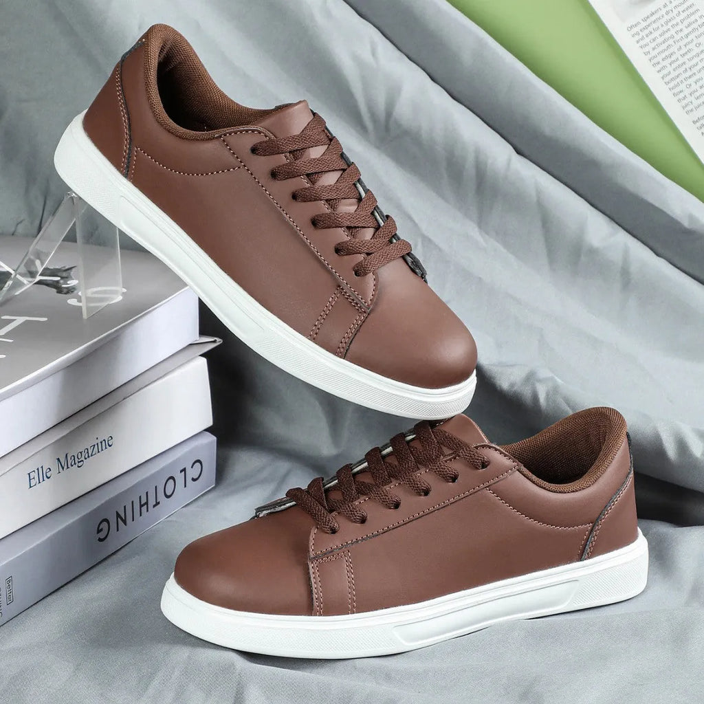 Beige brown platform casual skateboard sneaker with round toe and cross-strap detail on a white background.