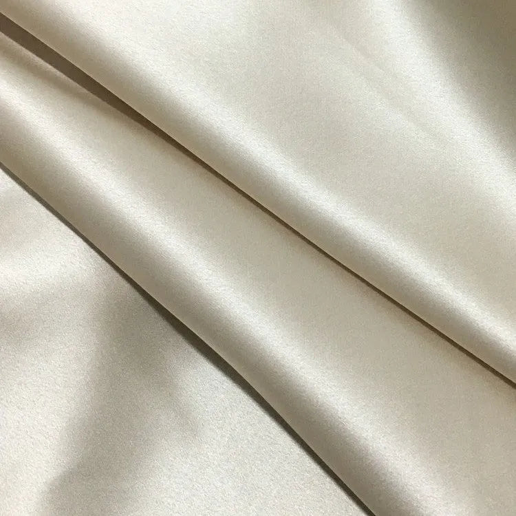 Dark grey 19 momme mulberry silk pillowcase showing envelope closure on a bed.