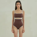 Brown women's one-piece swimsuit with a triangle top on a mannequin