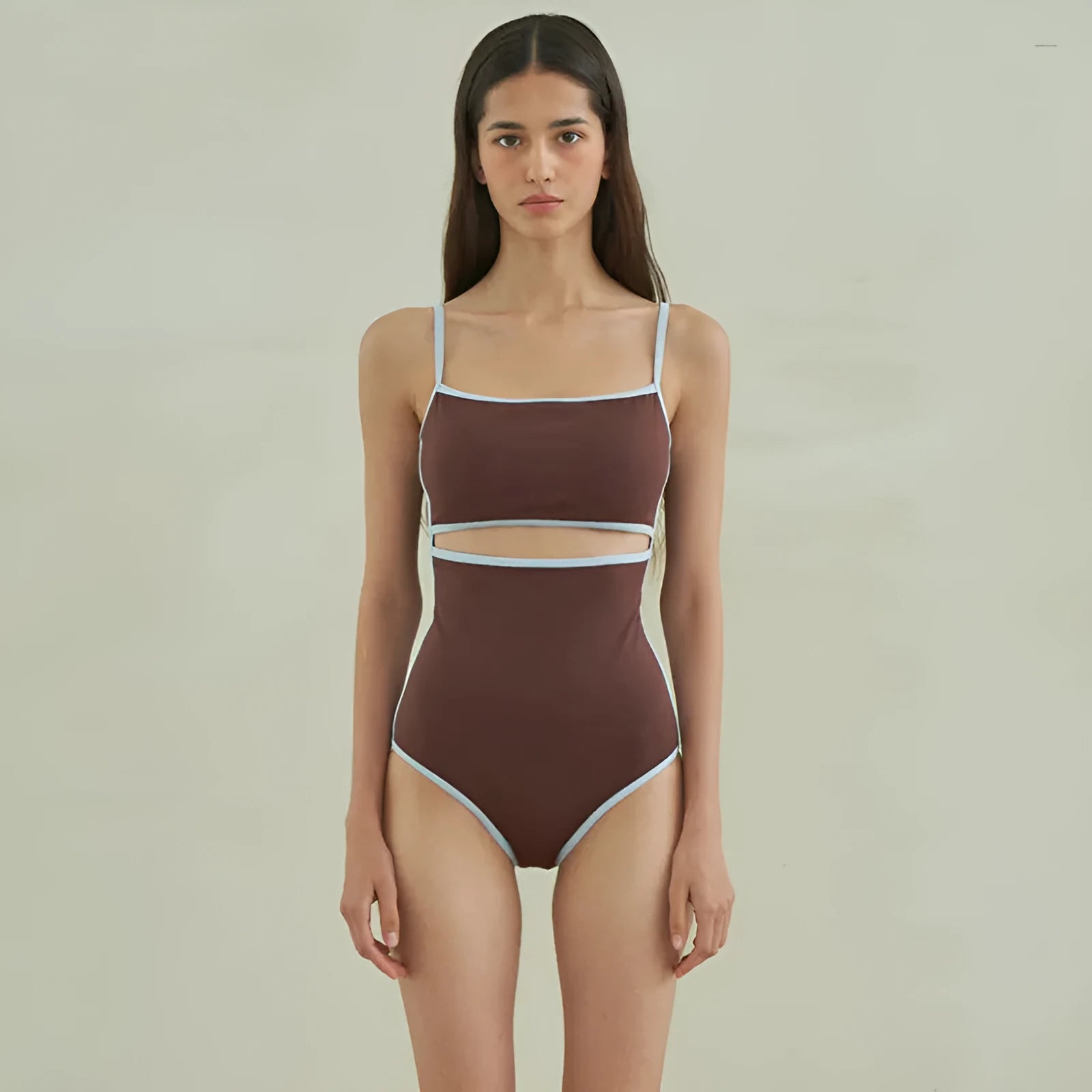 Brown women's one-piece swimsuit with a triangle top on a mannequin