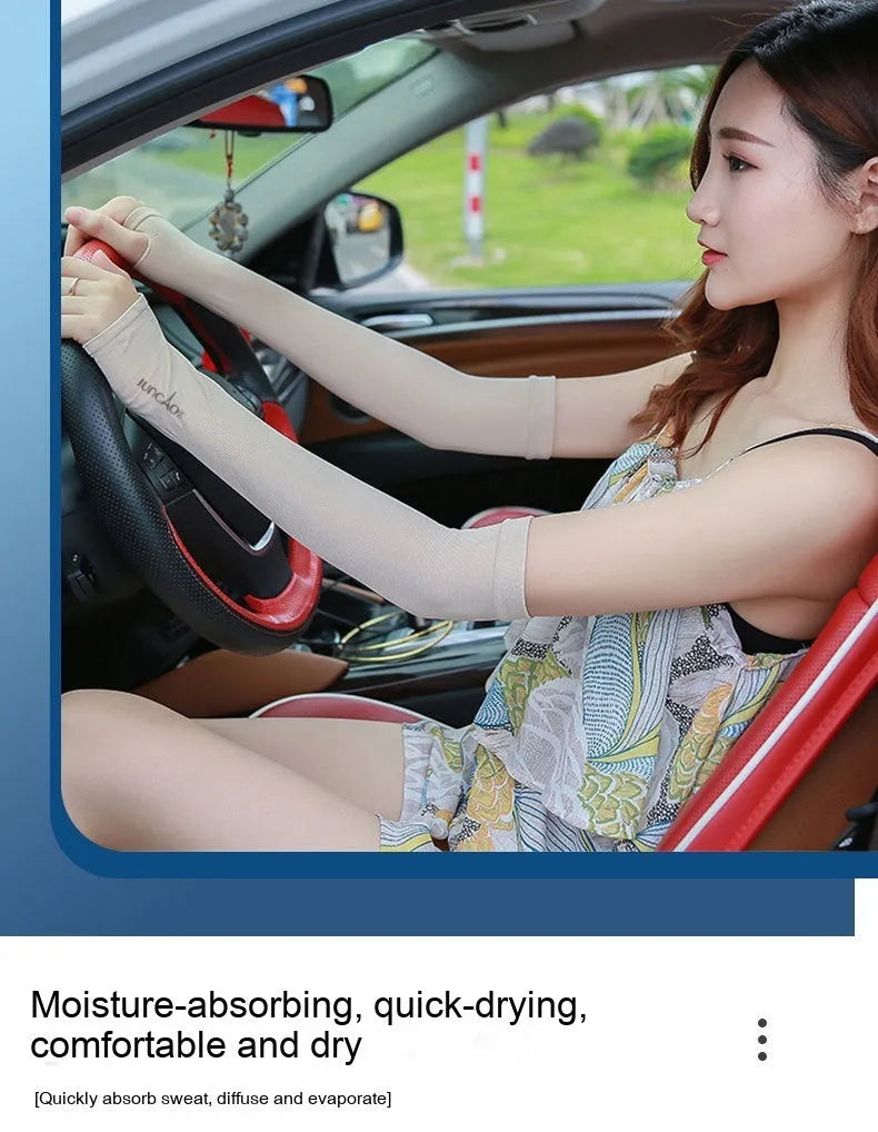 A person wearing a light grey nylon sun protection oversleeve on their arm with open fingers, suitable for driving.