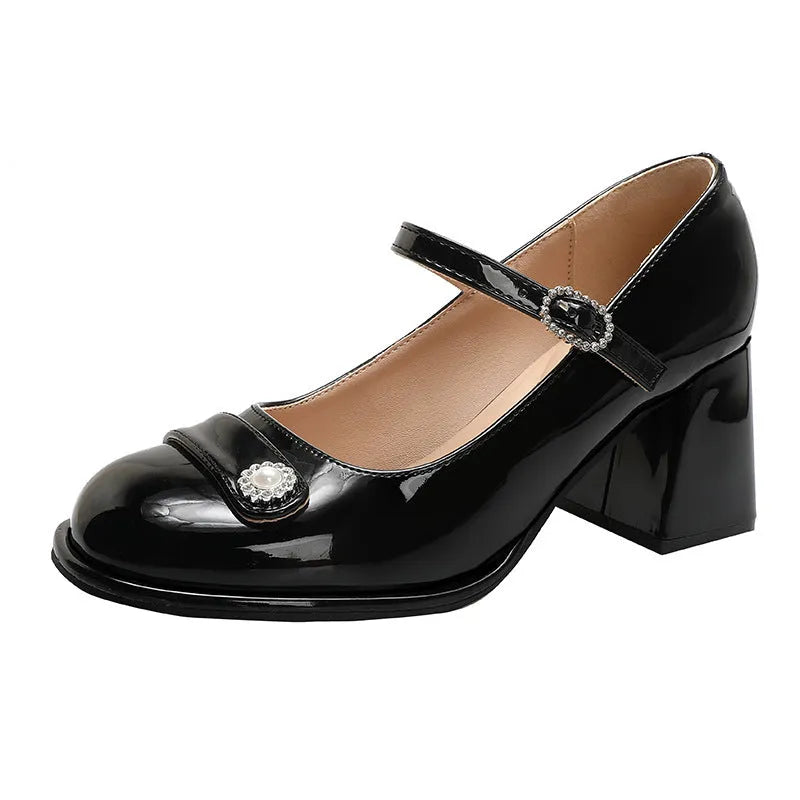 Women's black patent leather chunky heel shoes with round toe and buckle, shown in a larger size.