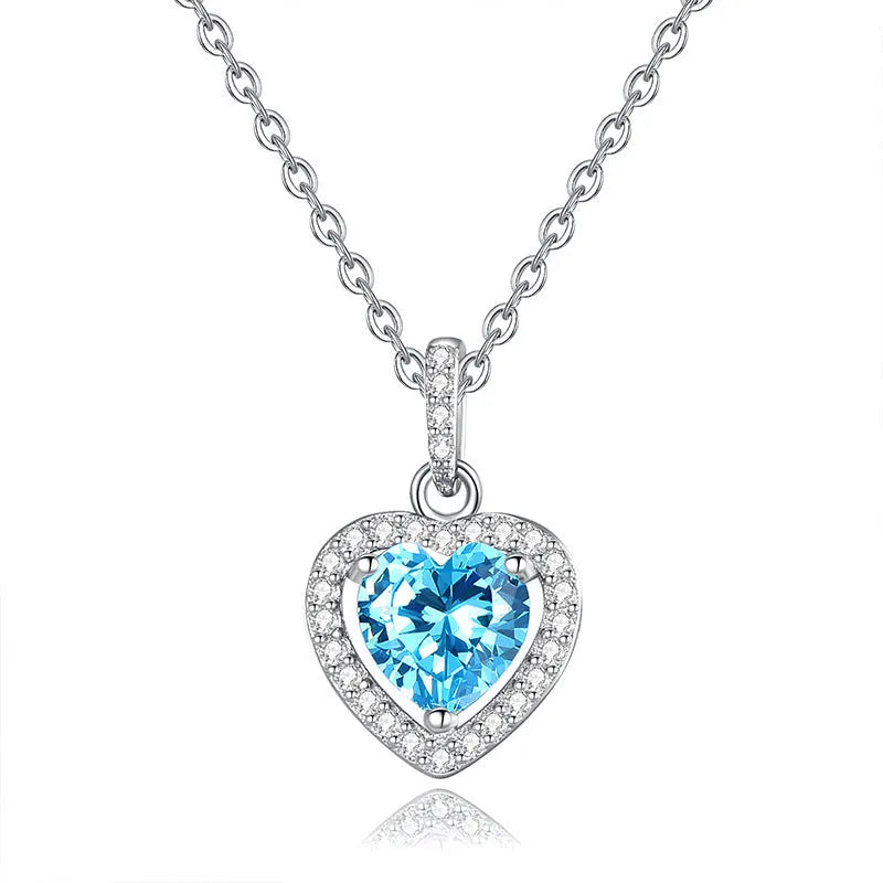Sterling silver heart pendant necklace with a natural gemstone on an adjustable cross chain.