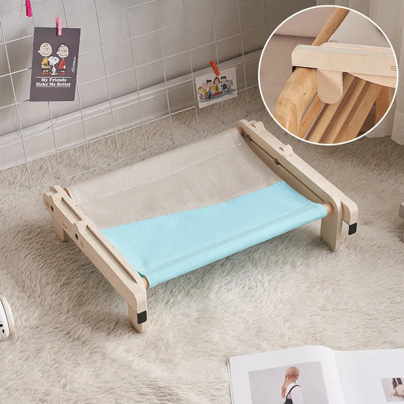 Solid wood pet bed for cats with removable washable cover in black and white plaid pattern on floor