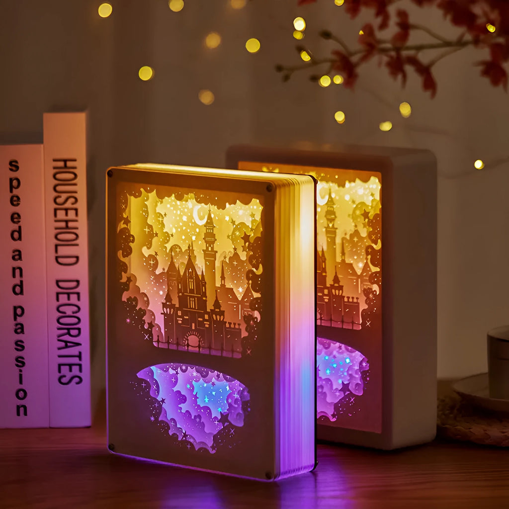 Bedside night light with 3D paper carving design, USB cable, and remote control on wooden surface