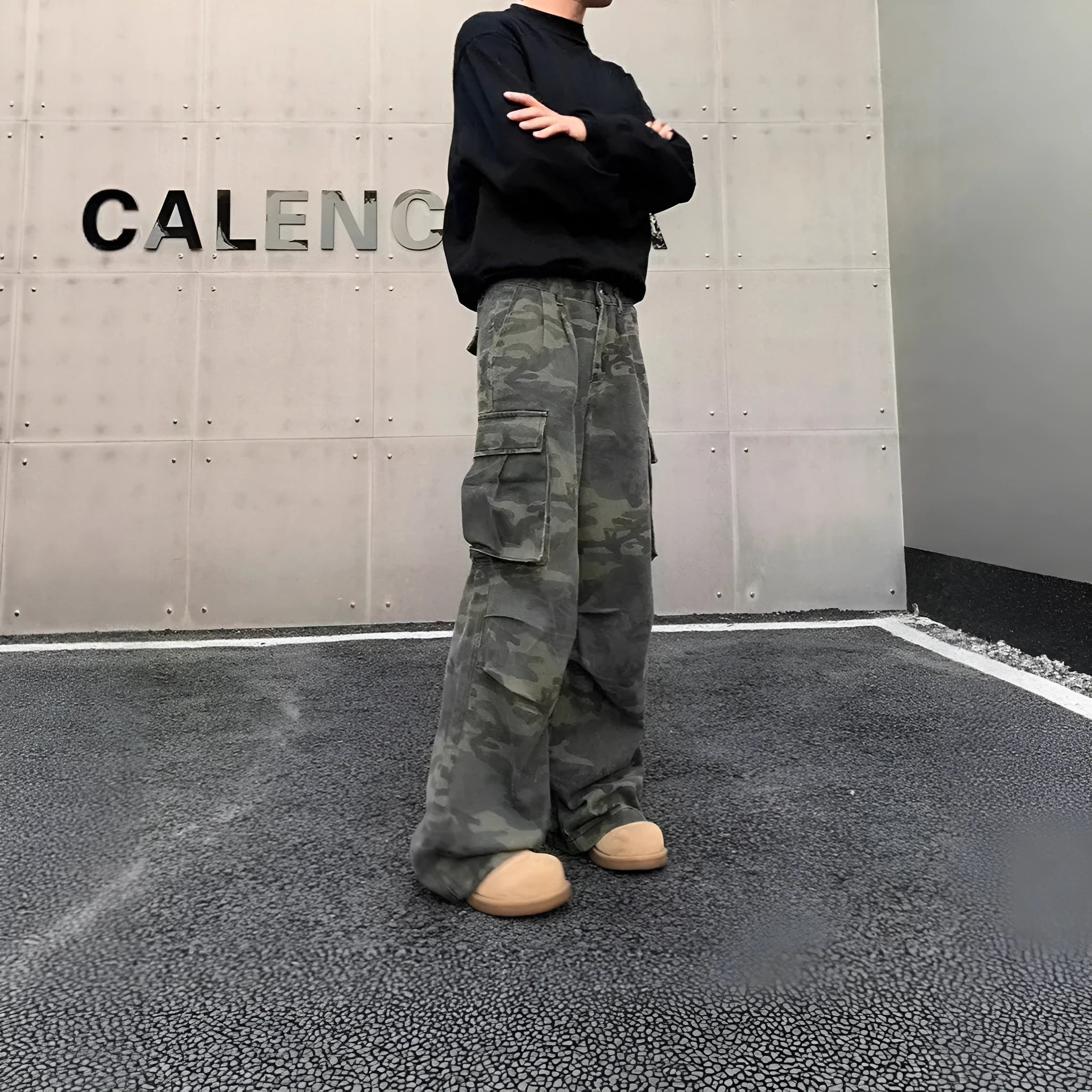 Washed camouflage cargo trousers with multiple pockets on a mid-waist fit.