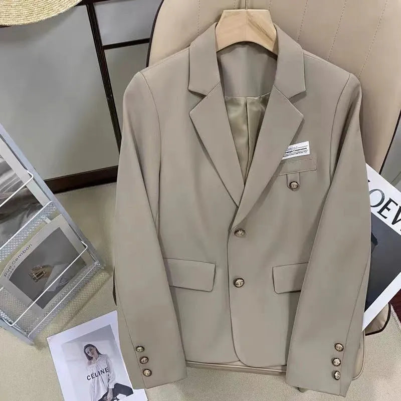 Women's black short suit coat with loose fit, long sleeves, and pockets for commuting style