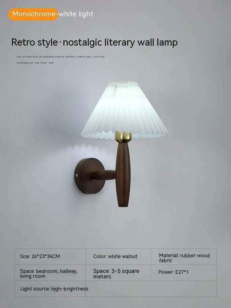 American retro-style wooden wall lamp with a fabric shade in a walnut finish on a bedroom wall.