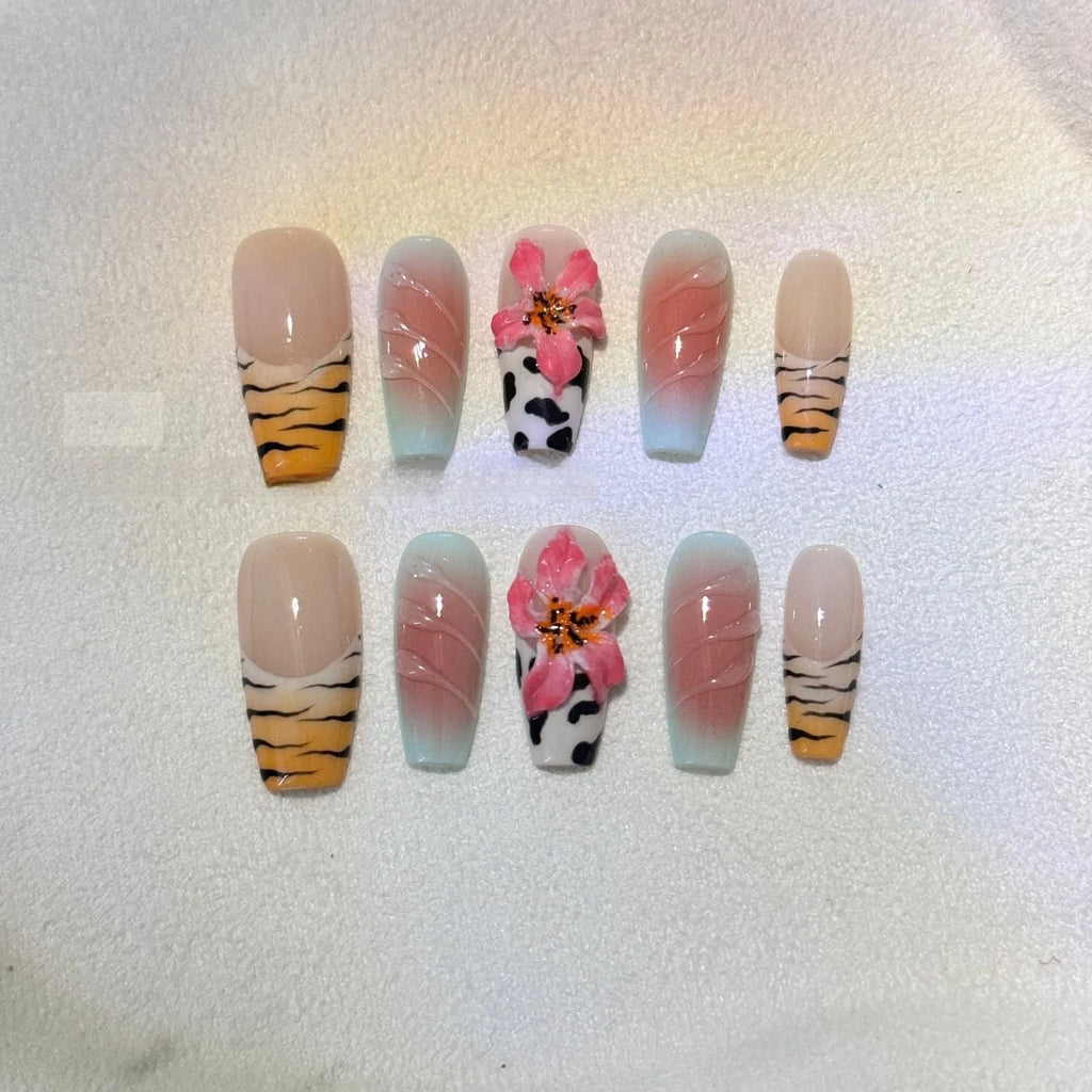 Hand-carved zebra pattern lily nail art set showing floral, leopard print and embossed designs in multiple sizes