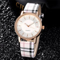 Gold black women's leather strap quartz watch with round 32mm dial and slim 6mm case