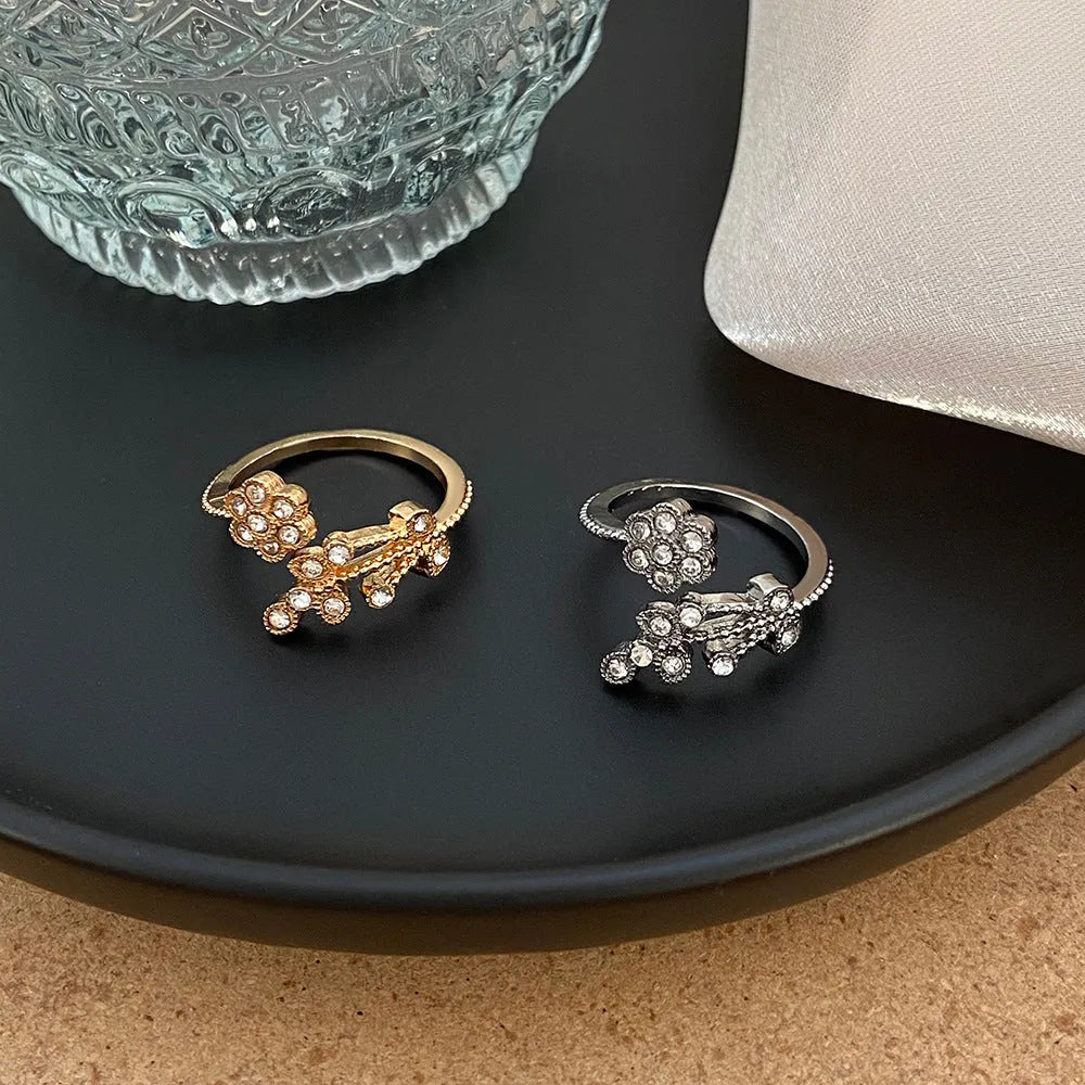Women's copper open ring with white and gold flower leaf design and diamond style finish