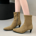 Brown square toe ankle boots with a side zip and a low kitten heel on a waterproof platform.