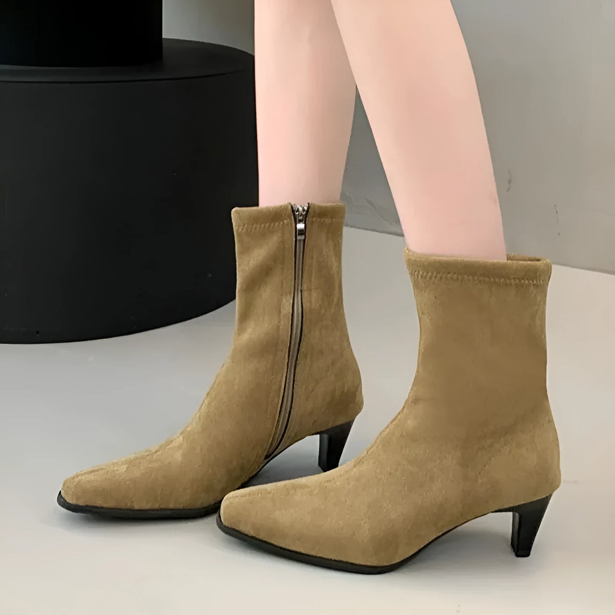 Brown square toe ankle boots with a side zip and a low kitten heel on a waterproof platform.
