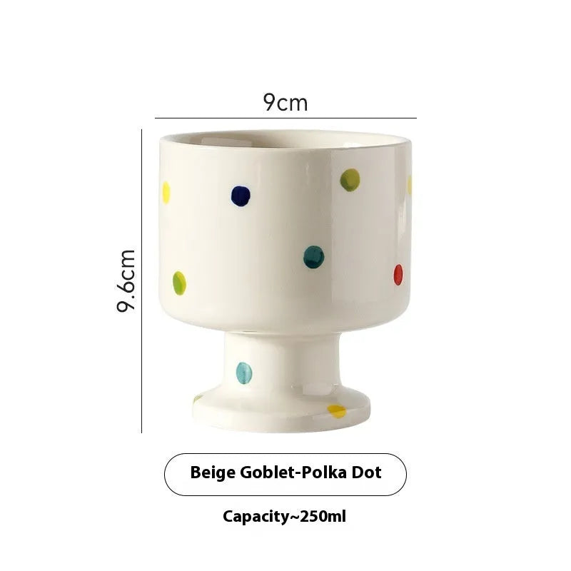 Hand-pinched irregular shaped solid colour ceramic mug on a table, showing its unique form and modern simplicity design.