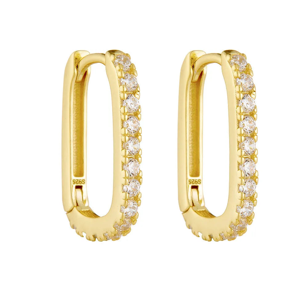 A pair of oval zircon clip earrings in sterling silver, shown in yellow and white finish options.