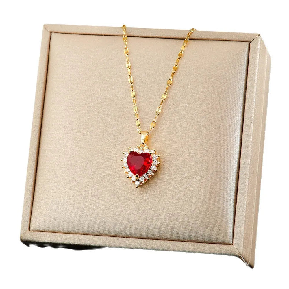 Gold red titanium steel necklace with heart and flower pendant, matching earrings, and ring.