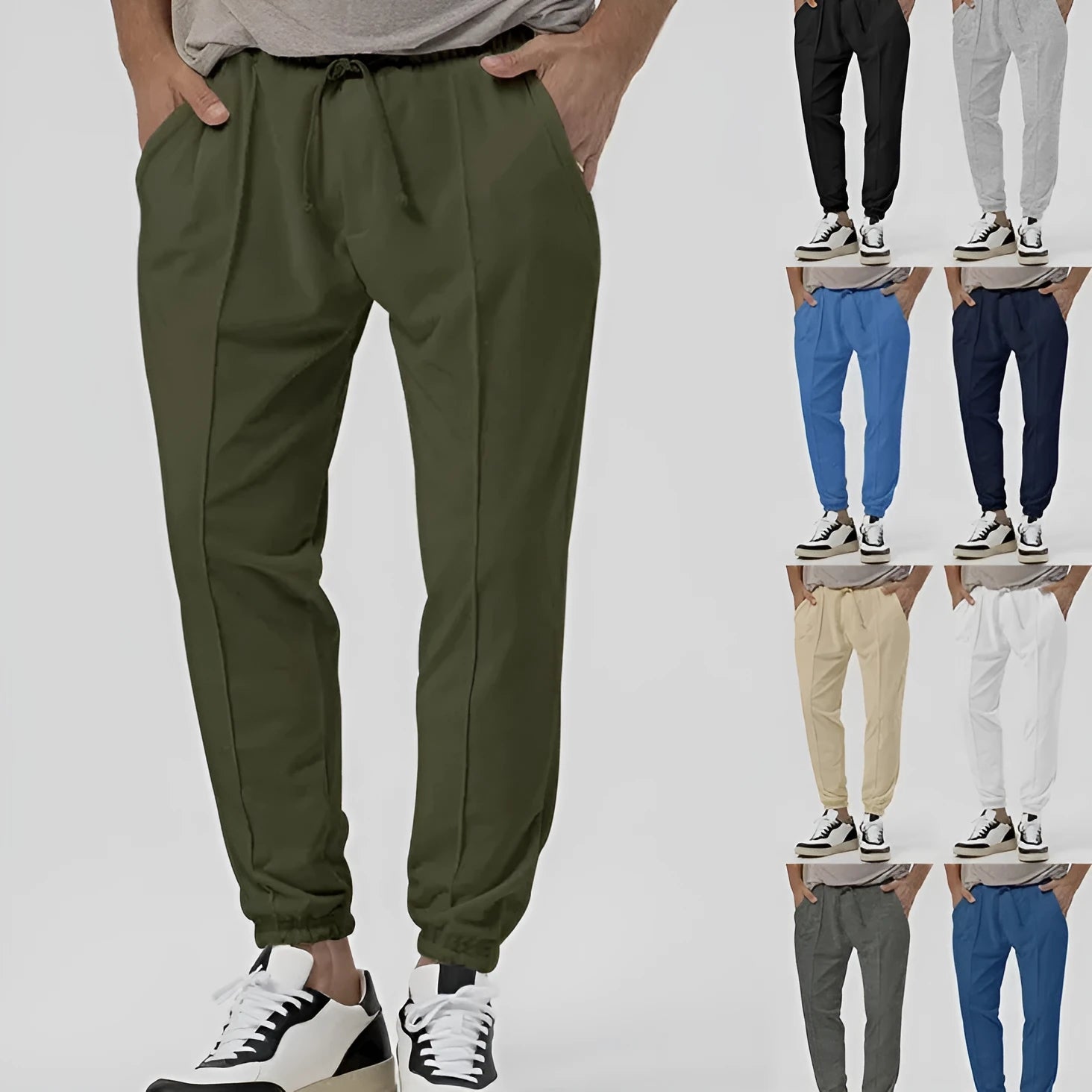 Man wearing grey loose tapered track sweatpants with a straight-leg design and elasticated waist.